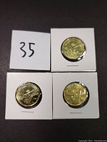 Three 2017 Canadian uncirculated $1 coins in white cardboard holders featuring Toronto Maple Leafs hockey themed designs.