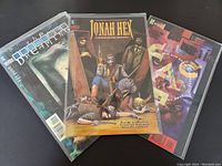 Photo of three 1990s DC Vertigo comics: The Dreaming #2, Jonah Hex #2, Face #1, each in protective bags with boards.