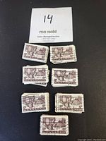 Stack and loose view of 10 cent brown Canadian stamps from 1950 with Scott #301