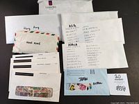 Envelopes and labeled sleeves organizing stamps by country and continent including Asia, Africa, Australian Commonwealth, Japan, Hong Kong, listed with handwritten notes.