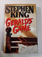 Front cover of the book showing the title and author's name with a bedpost and handcuffs graphic.