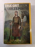 Front cover of the book showing illustrated artwork of a woman holding a rifle in a bohemian style landscape.