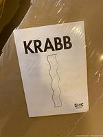 IKEA KRABB assembly instruction booklet showing wavy design of mirror.