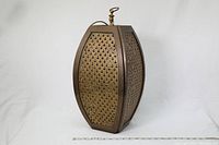 Full view of the large brass hanging lamp with sides perforated in a consistent design and a decorative finial on top. The lamp is positioned upright showing its general shape and proportions.