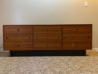 Front view showing nine drawers and integrated legs