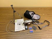 Full lot overview including Canon camera, tripod, memory cards, remote, manual, shutter release cable, and carrying case