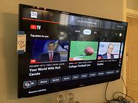 Samsung 46" TV mounted on wall displaying YouTube TV interface