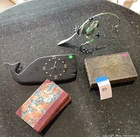 Overview of jewelry box, whale clock, books and frog sculpture
