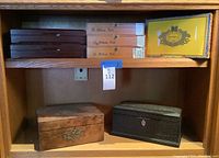 Wooden shelf with mixed wooden and cardboard boxes