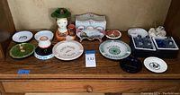 Full display of all 16 ceramic items on a wooden shelf