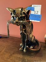 Front view of metal cat sculpture showing face and whiskers