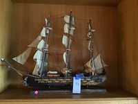 Front view showing full hull, sails, masts and base