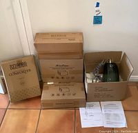 Photo of the collection showing four boxed items: Belador comforter, Beckham fiber pillows (3-pack), and two Meoflaw pillows along with the lamp fixture box