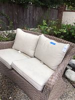 Front view of loveseat showing frame and cushions