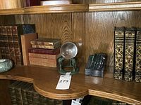 Shelf view showing books and decor items.