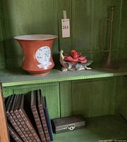 Front view of planter, lotus sculpture and metal horn candleholder