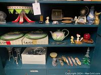 Wide view of shelves holding ceramic Easter dishes and small decor items