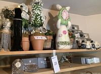 Shelves with decorative jewelry trees, Easter bunny decor, and boxed Waterford crystal items