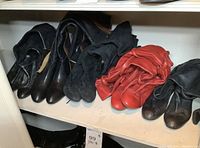 Five pairs of boots on shelving