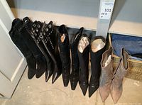 Frontal view of five pairs of boots in row showing shafts and toes