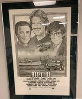 Framed Riptide promotional poster under glass with black frame and off-white mat, depicting cast illustrations, a yacht, a speedboat, helicopter and credit block.