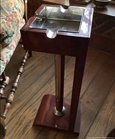 Side view of standing ashtray showing wood frame, chrome column and stainless steel tray