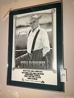 Frontal view of the framed poster showing image, rope border, title and production credits.