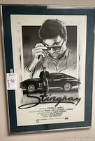 Framed Stingray poster showing lead actor adjusting sunglasses over a vintage car illustration