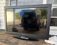 31-inch Element flat-screen television shown from front and side angle with remote placed in front.