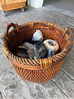 Woven basket from top showing yarn balls and crochet supplies inside.