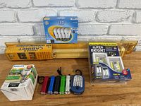 Photo showing all lot items arranged on table against white brick wall background