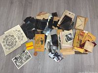 Overview photo showing large quantity of photo negatives in piles, old black and white photos, envelopes, and paper ephemera