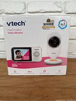 Front box image showing VTech branding, product image with camera and handheld monitor, and 2.8 inch screen size.