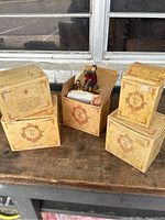 Five vintage style decorative boxes labeled Yesterday's Child, four closed and one open showing a figurine inside with a child pulling a sled.