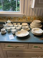Overall view of entire dinnerware set on countertop