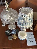 Photo of cut glass lamp with silver hardware, blue and white ceramic lamp with windmill shade, matching cup, and five small trinket or pill boxes.