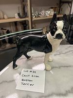 Side angle of cast iron Boston Terrier dog figurine painted black and white with note reading 'Lot 39 Cast Iron Boston Terrier'