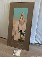 Full view of the framed San Diego Half Marathon poster showing the tower, palm trees and soft color gradient background with signature and number at the bottom.
