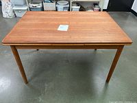 Front view of teak extendable dining table