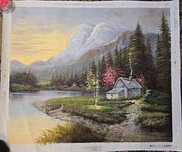 Front view of the signed landscape oil painting showing a lakeside cabin, trees, mountains, and a sunset sky.
