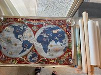 Flat laid linen-backed Air France world map with rolled maps at right