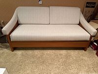 Front view of sofa in closed position showing full width, armrests, back cushions and upholstery.