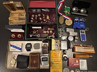 Overall layout of accessories, cufflinks, watches, lighters and keychains