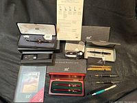 Overall view of all pens, cases, boxes, documentation, ink bottle, refills and nib section
