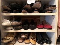 Overview showing five pairs of flats in assorted colors on shelf