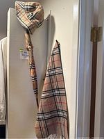 Full view of scarf, bucket hat and umbrella hanging together