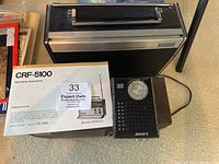 Sony CRF-5100 radio with owner's manual and small mini radio on top.
