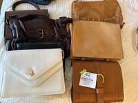 Lot of six women's leather purses in shades of tan, fawn, ivory and chocolate, varying textures and styles in a single photo