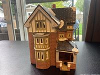 Single Yule Tide Christmas Village house resembling a Calgary Mansion with detailed architectural features and snow accents.