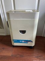 Front view of the beige Royal Platinum Series document shredder with a transparent window in the large collection bin.